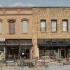 This iconic downtown café and antiques business has been a cornerstone of the Bowie, Texas community for more than 30 years. The operation uniquely combines a full-service lunch café and dessert bar with a large, curated antiques showroom, creating a destination experience that drives long visits, repeat traffic, and multiple revenue streams under one roof. The café serves made-from-scratch lunch offerings alongside nostalgic desserts such as banana splits, pies, cakes, brownies, and bread pudding. Customers frequently arrive for lunch or dessert and remain on-site browsing antiques, often returning for future purchases or estate sale events. This dual-business model has proven highly effective as each side drives traffic to the other. The business operates out of two connected historic buildings totaling approximately 18,000 square feet, owned free and clear. Ownership has expressed a strong preference to sell the business together with the real estate, creating a rare opportunity to acquire both a profitable operation and valuable downtown property. Financially, the business generates approximately $650,000 to $750,000 in annual revenue, with the seller estimating operating margins near 60%, resulting in approximately $200,000 in annual cash flow. The operation has historically been cash-heavy, and all financial figures are based on seller representations. The antiques inventory has been curated over more than three decades and is believed by the seller to be valued at or near the asking price of the business alone, offering significant built-in asset value. The staff consists of five to six experienced employees who have expressed a desire to remain with the business under new ownership, ensuring continuity and a smooth transition. This is a true lifestyle and investment opportunity featuring immediate cash flow, deep community roots, paid-off real estate, and meaningful upside through expanded hours, catering, marketing, estate sales, and additional offerings.